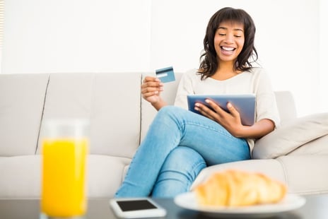 Person enjoying shopping online using a tablet as part of following the best eCommerce tips for success.