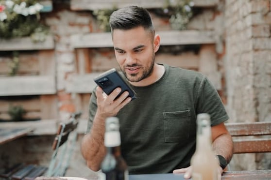 Man talking into the phone using voice search.
